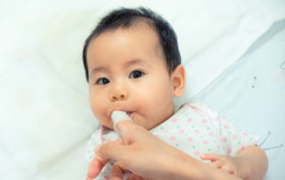 Wipe baby's teeth with a soft cloth