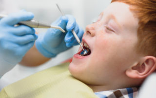 Boy satisfied with the service in the dental office.